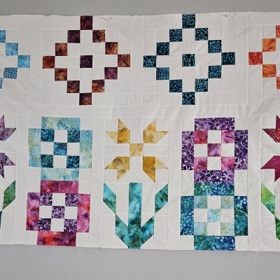 I'm using batiks and natural muslin for the background.