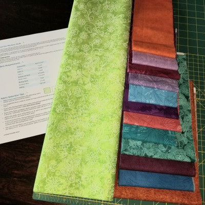 Using a lot of Brights leftover from a prior quilt kit, with lime green backgrou